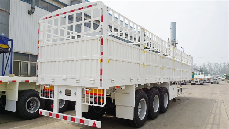 Rear 45-degree view of Kales 60-ton fence semi-trailer with dropsides and steel stakes.