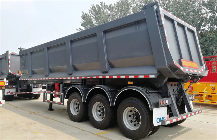 Rear view of heavy duty dump trailer with reinforced chassis and flipping brackets.